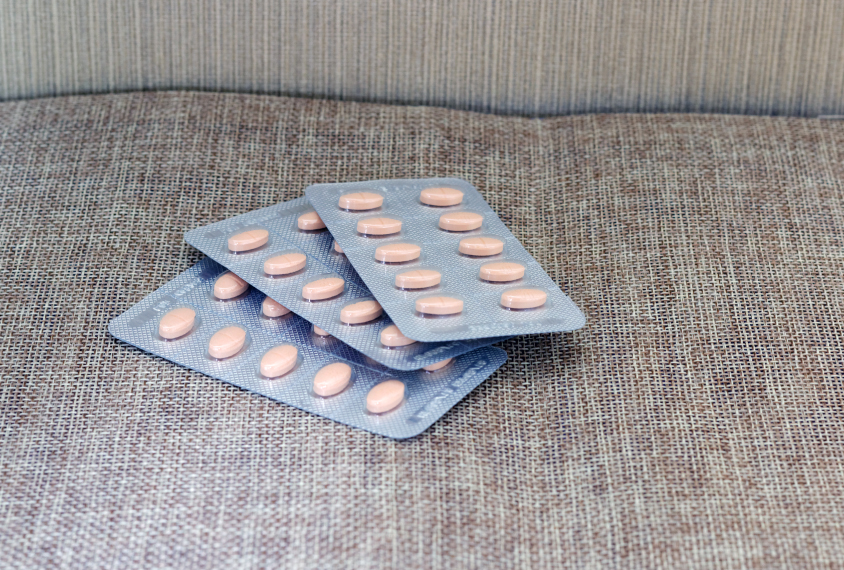 Statin pills in a blisterpack on a couch.