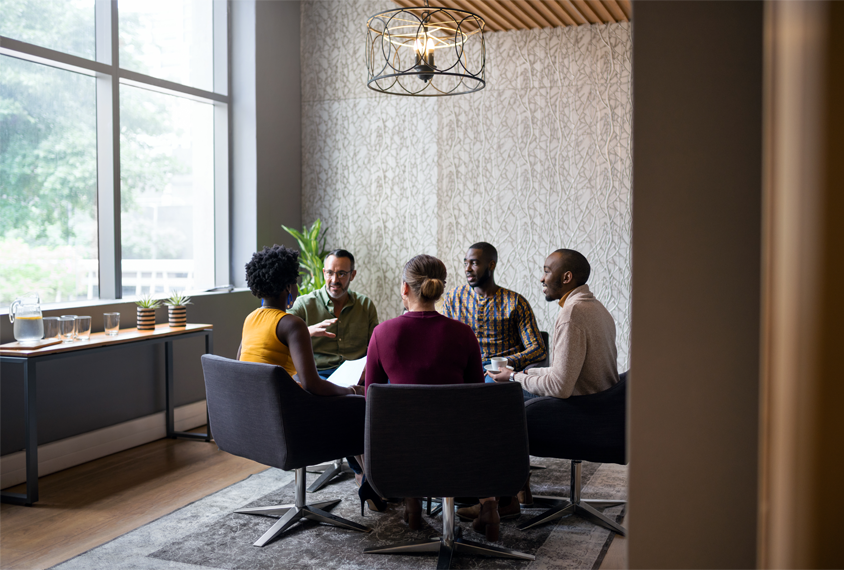 Photo of a group of adults sitting and talking.