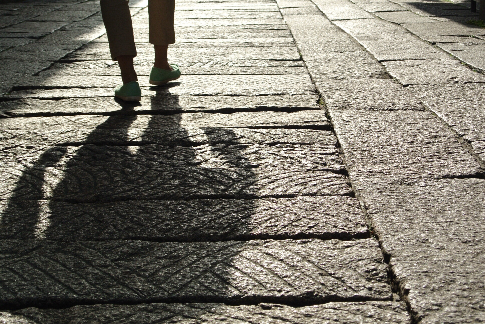 person walking down sidewalk