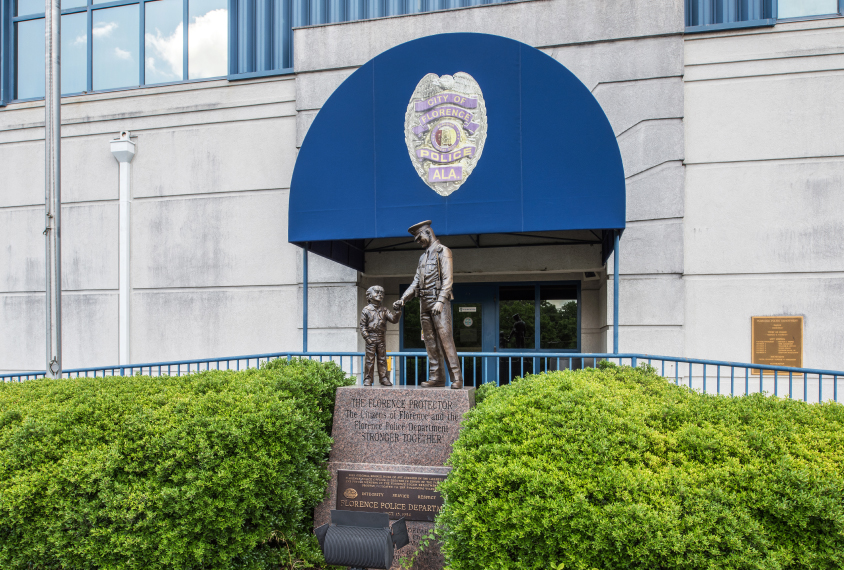 Front of Police station, a statue shows a police officer interacting with a child.