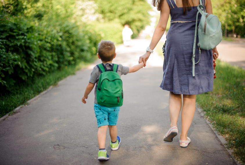 Mother walking kindergarten age child