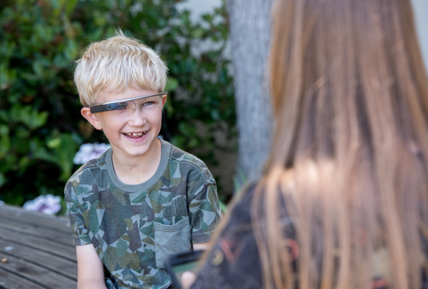 boy wearing high-tech glasses, smiling