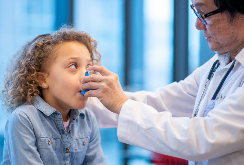 Young child getting an asthma treatment from a doctor