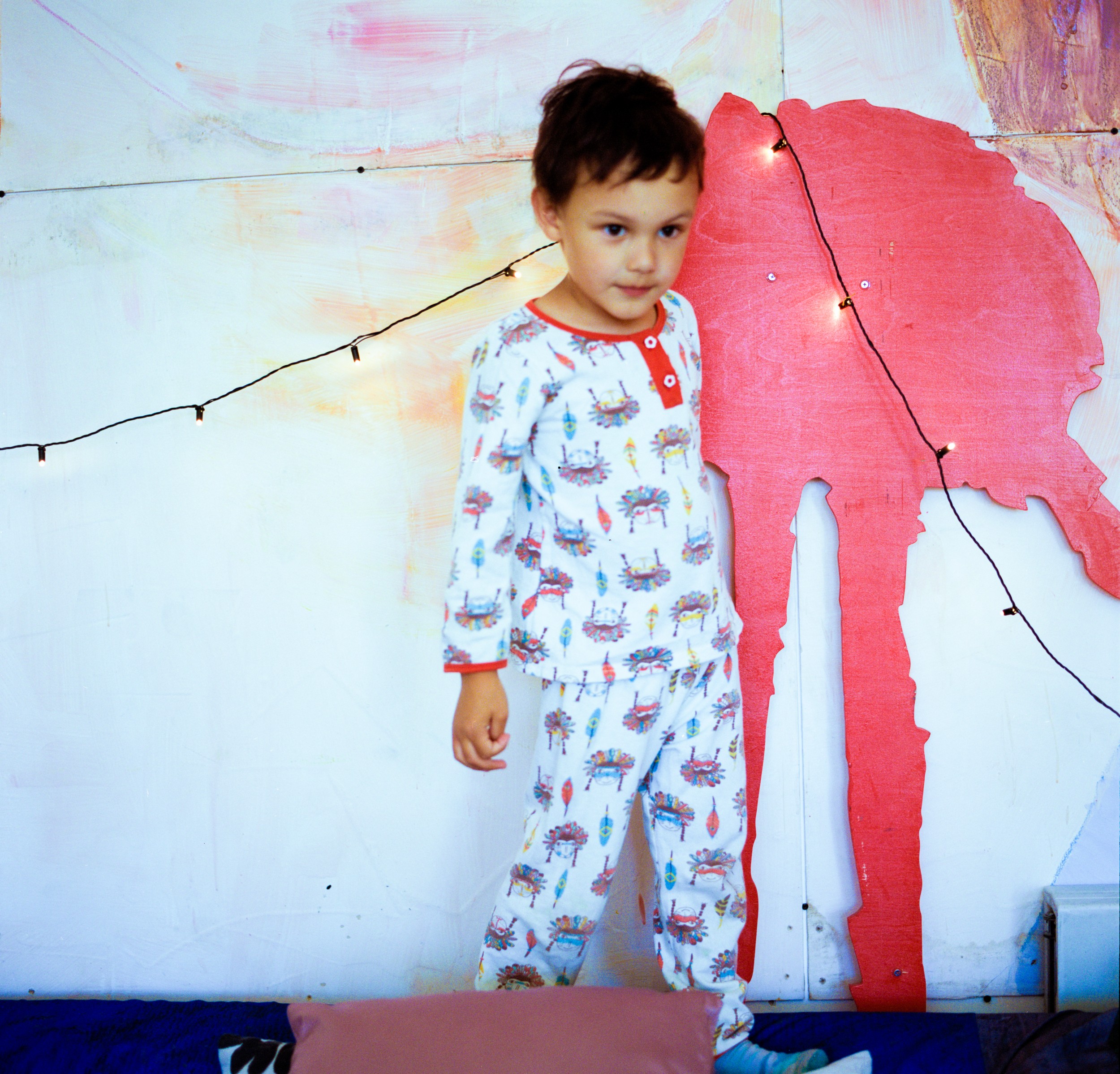 Young boy at a city camp for autistic children in the colorful playroom.