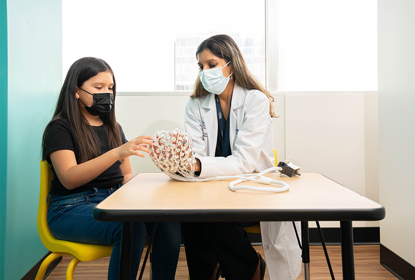 Dr. Jeste with a patient and an EEG cap.