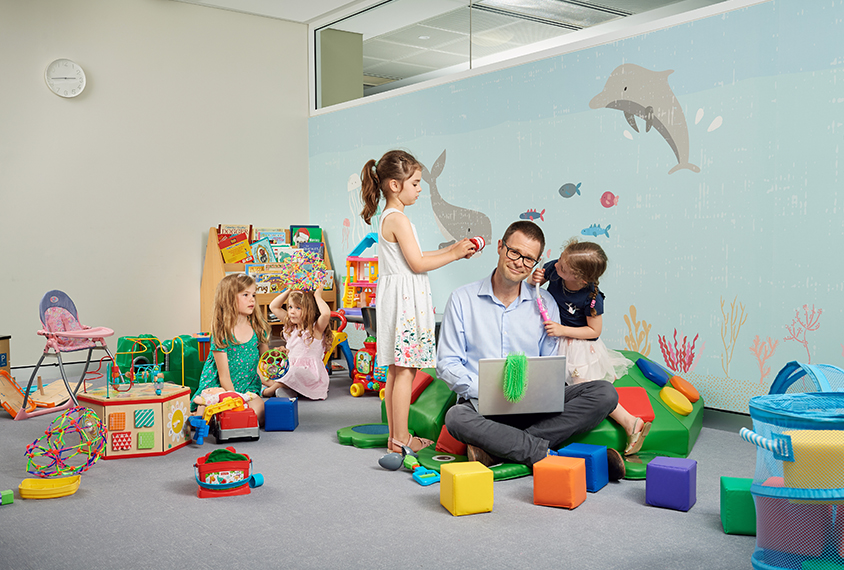 Professor Andrew Whitehouse surrounded by playful children in the busy clinic in Subiaco Western Australia.