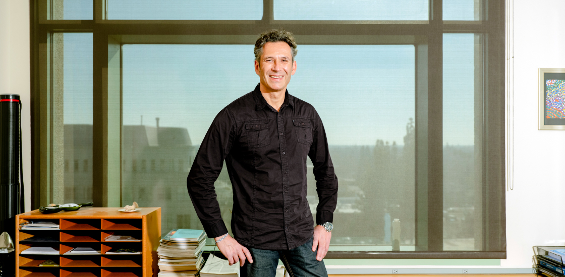 Dr. Kostas Zarbalis standing in front of a window in his office.