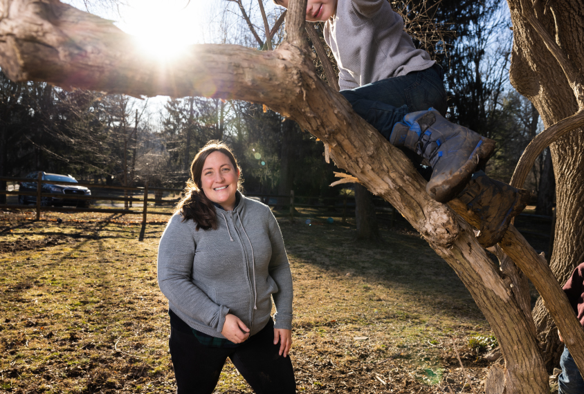 Lindsay Shea hiking and child climbing tree.