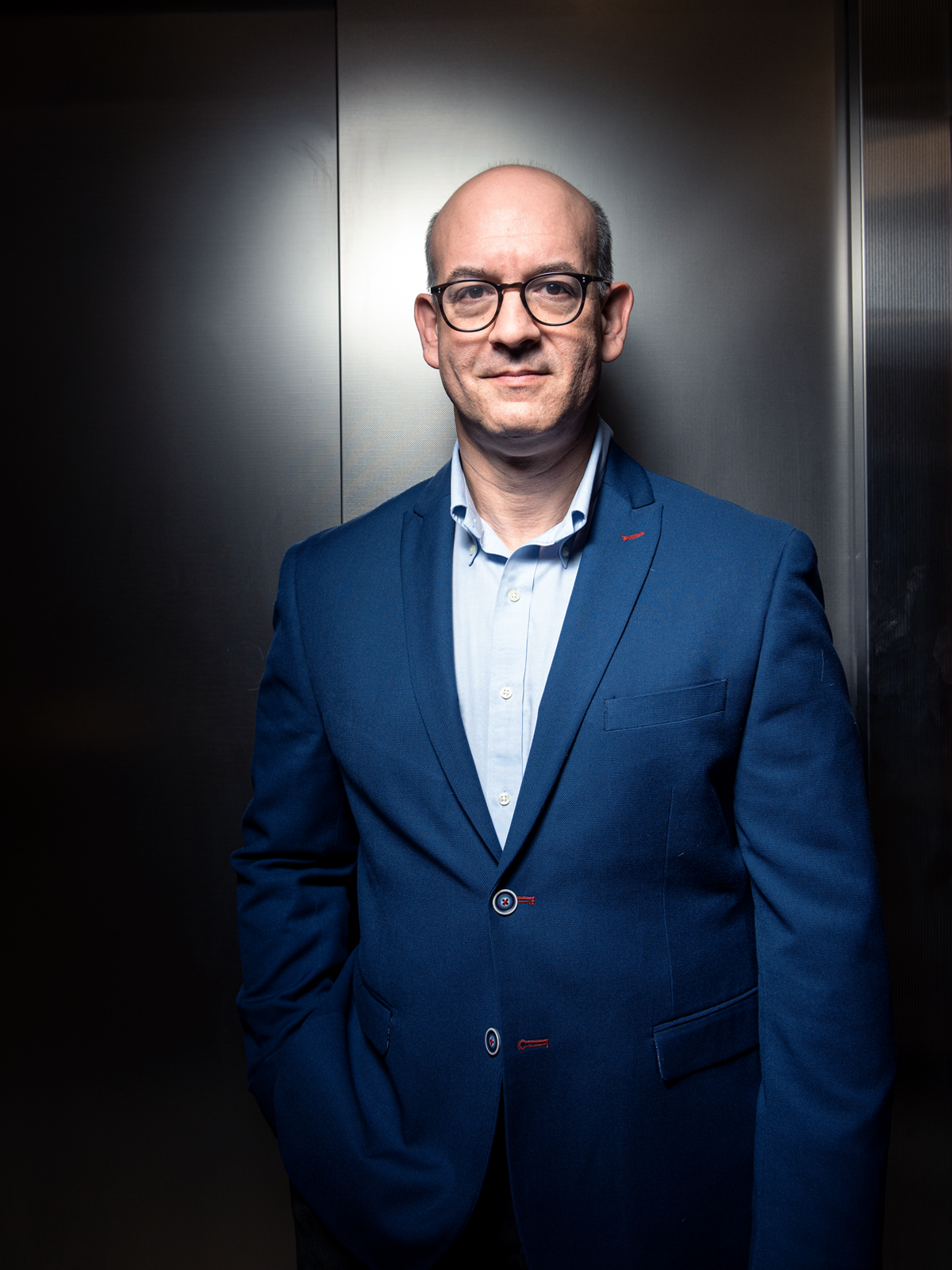 Portrait of Matthew Siegel standing in an elevator.