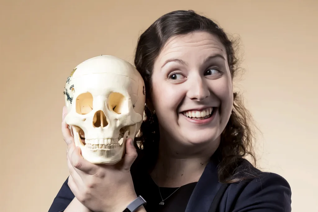 Photograph of Kaitlyn Casimo posing with a skull.