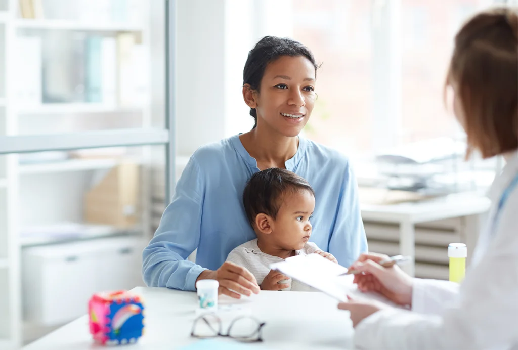 Stock photograph of a women and her young child at a clinician’s office.