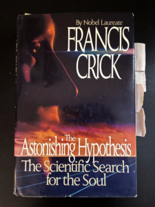 Photograph of Nicole Rust's copy of Francis Crick’s book “The Astonishing Hypothesis: The Scientific Search for the Soul,” which has post-it notes marking specific pages.