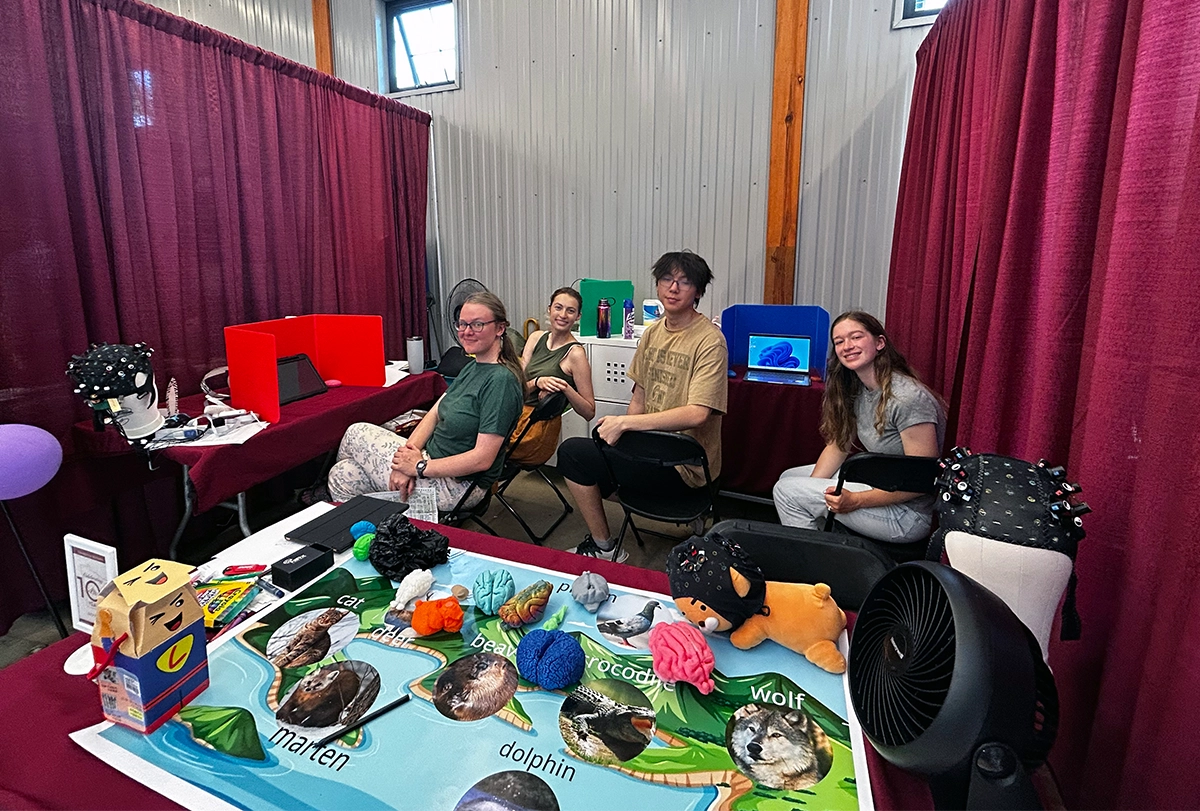 Photograph of Ka Ip’s staff in their booth at the Minnesota State Fair.