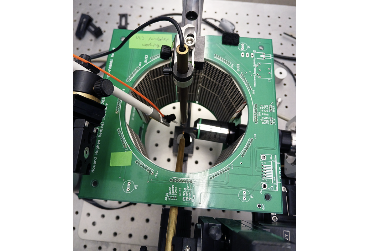 Photo of a virtual reality flight arena: a cylindrical array of panels encircled on top by a printed circuit board.