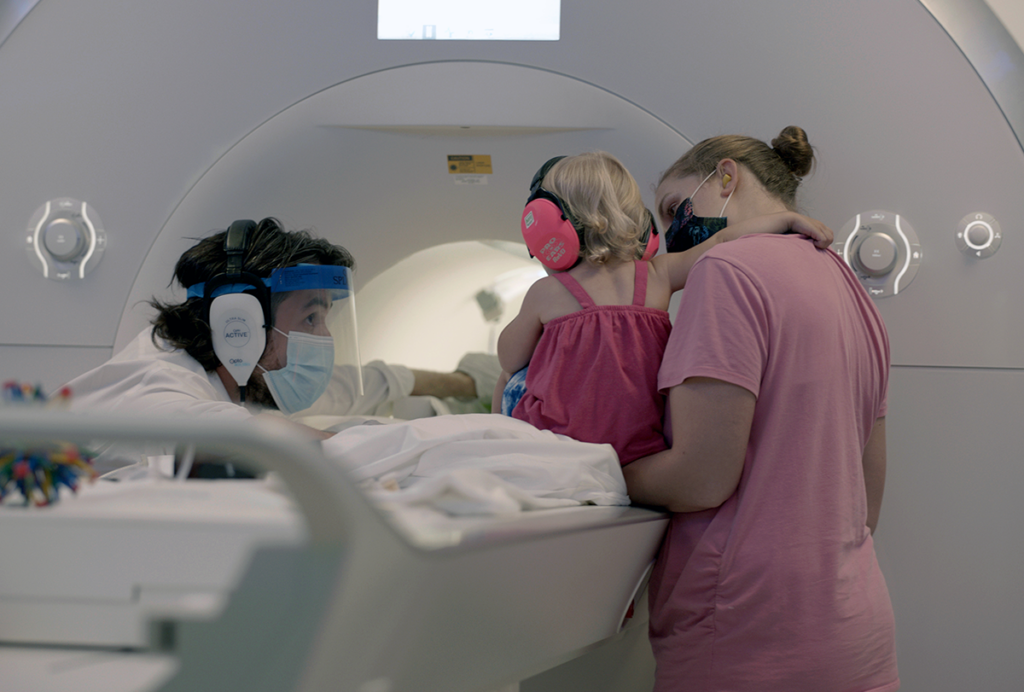 Cognitive neuroscientist Nick Turk-Browne helps an infant into an fMRI machine.